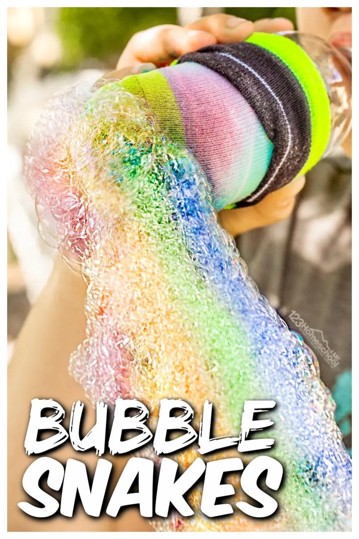 a person holding a bottle filled with rainbow colored bubbles next to the words bubble snakes