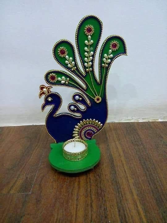 a peacock figurine sitting on top of a wooden floor next to a clock