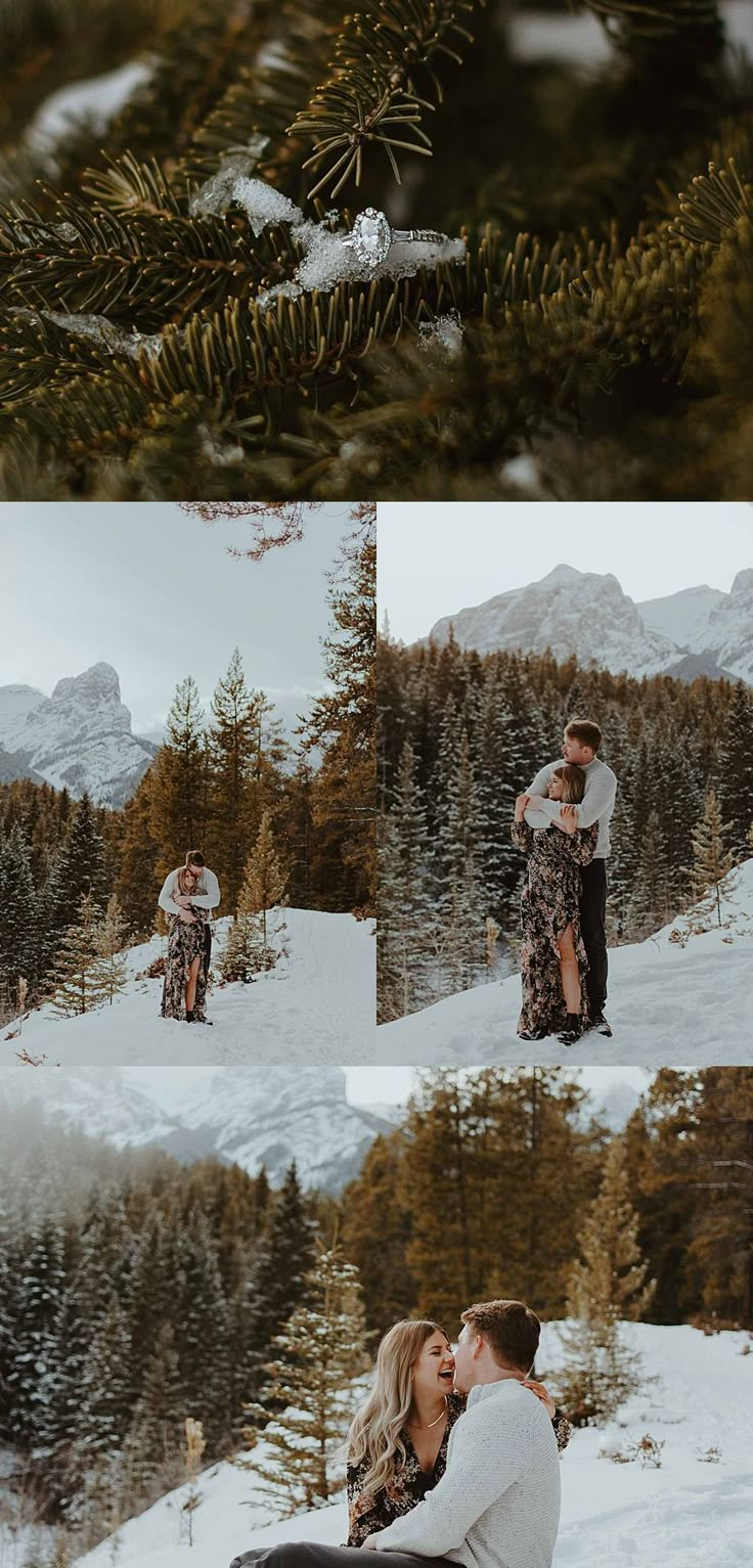 a couple kissing in the snow surrounded by pine trees and evergreens with mountains in the background