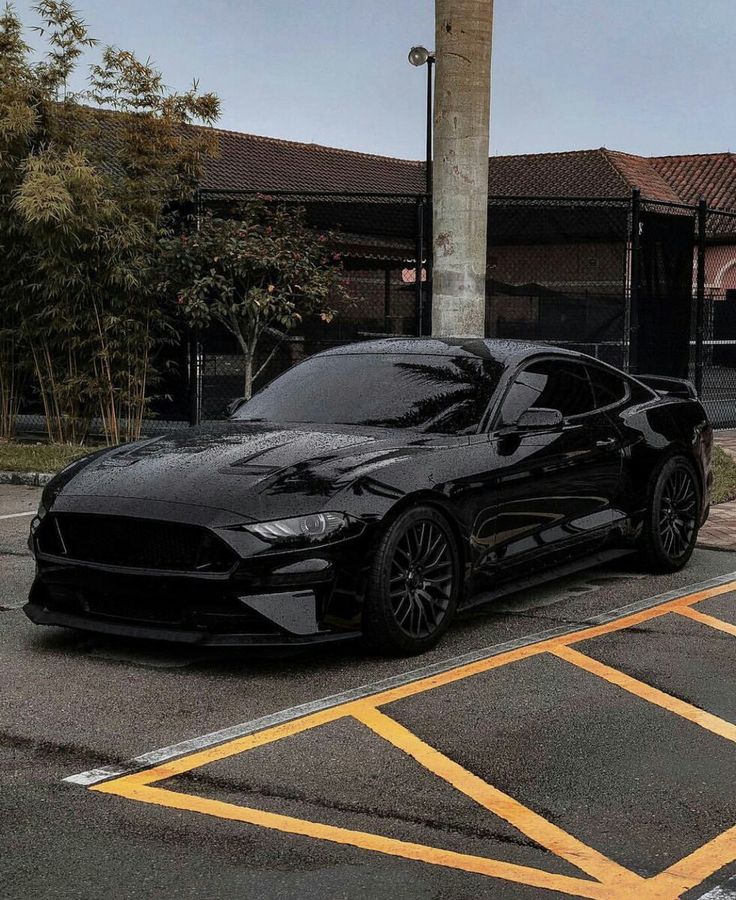 a black sports car parked in a parking lot