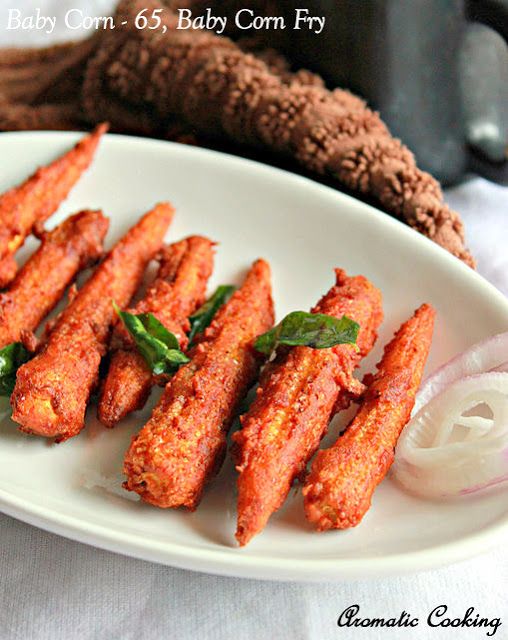 fried baby carrots on a white plate with onions