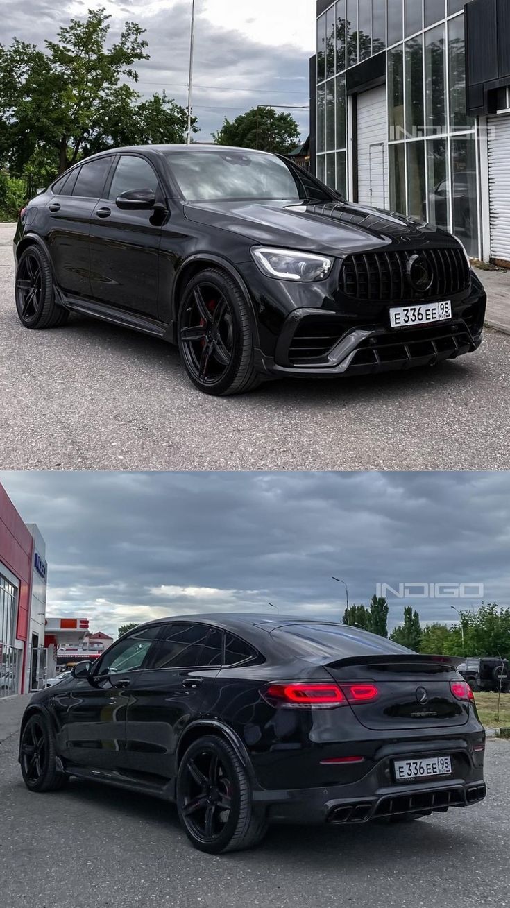 two cars side by side in front of a building and the other one is black