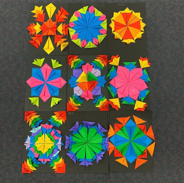 several different colored origami pieces laid out on top of each other in squares