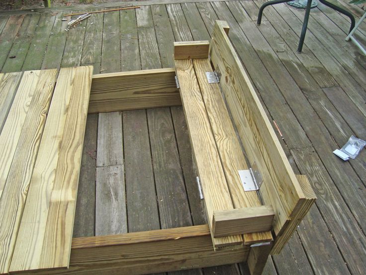 a wooden bench sitting on top of a wooden deck