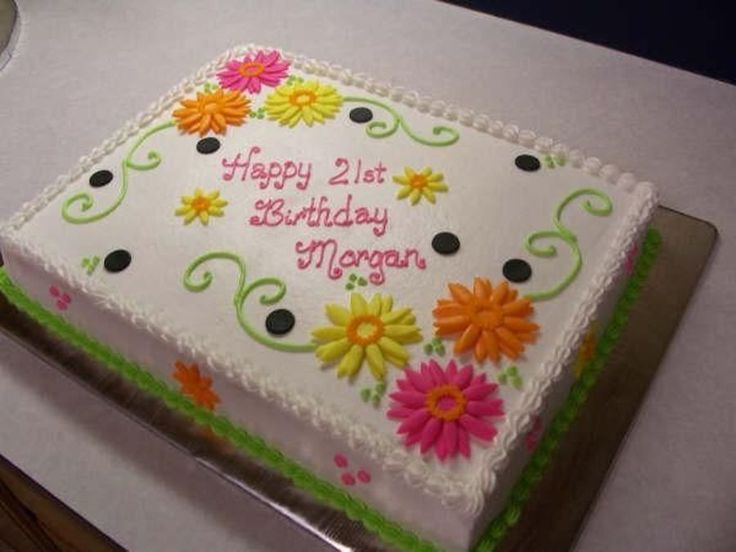 a birthday cake with flowers on it sitting on a table