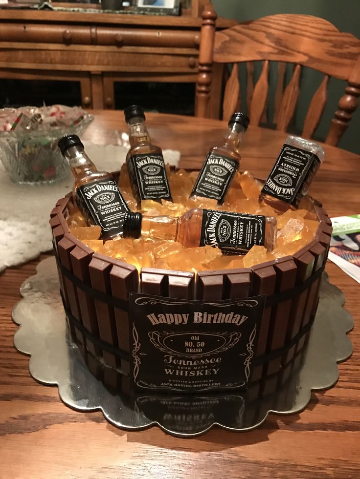 a birthday cake with bottles of whiskey on it