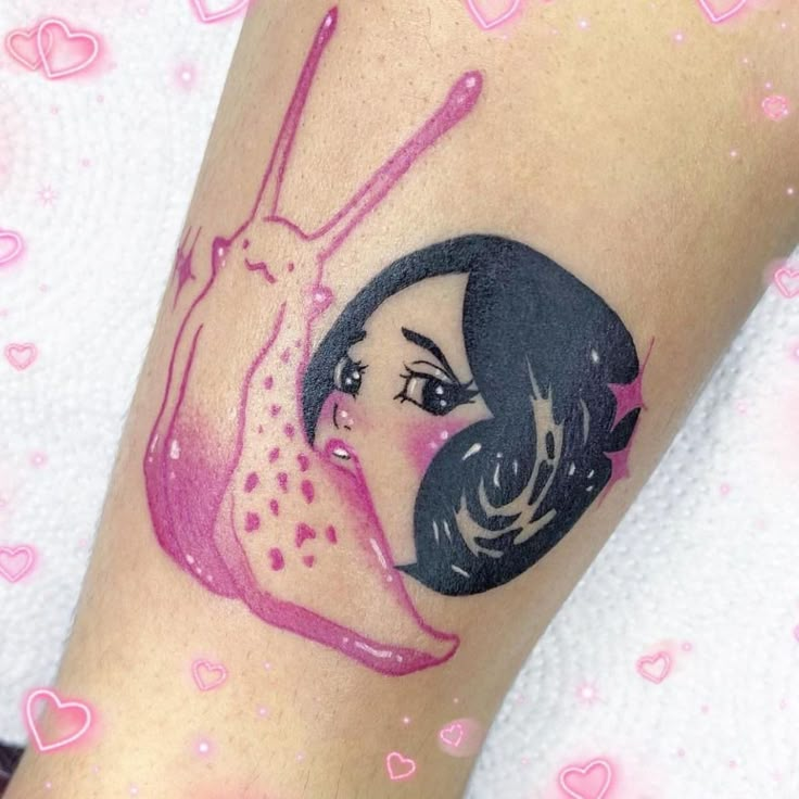 a woman's arm with a pink and black tattoo design on the left side of her leg