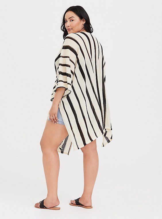 A striped ruana gives you an instant boho look, while lightweight fabric keeps you feeling (and looking) cool all summer long. Open front. Side self-tie; vented. 3/4 sleeves. CONTENT + CARE: Acrylic. Hand wash; dry flat. Imported plus size kimono. SIZE + FIT: Model is 5'10”. This item is One Size and measures 37. 25” from shoulder . The best plus size women's ivory & black stripe ruana capes ponchos ruanas in ivory. Torrid is your destination for cozy fall and winter clothes to keep you warm and Casual Spring Cover-up With Batwing Sleeve, Casual Spring Batwing Sleeve Cover-up, Casual Batwing Sleeve Spring Cover-up, Oversized Cover-up For Fall Day Out, Chic Beach Tunic For Fall, Chic Fall Beach Tunic, Oversized 3/4 Sleeve Beach Tops, Bohemian Striped Tops For Vacation, Casual Beach Tunic With 3/4 Sleeves