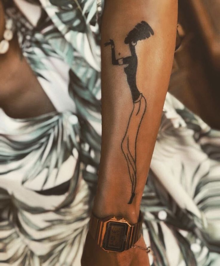 a woman's arm with an umbrella tattoo on it