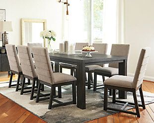 a dining room table with six chairs and a vase on the end shelf in front of it