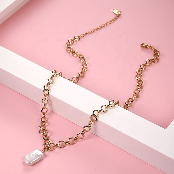 Introducing the Juliette necklace, a stunning piece that is sure to turn heads. Crafted with care, this necklace boasts an elegant and timeless design that is perfect for any occasion. The linked chain measures 15 inches with an additional 2 inches to allow for a comfortable fit on any neck. The necklace is made of high-quality 18k gold plating that not only looks beautiful but also ensures durability for long-lasting wear. The pendant features a delicate and stunning mother of pearl detail, whi Elegant Gold Chain Charm Necklace With Pendant, Elegant Gold Chain Pendant Charm Necklace, Elegant White Charm Choker Necklace, Elegant White Charm Necklace Choker, Elegant Charm Necklace With Link Chain, Elegant Metal Charm Necklace With Pearl Chain, Elegant Link Charm Necklace With Adjustable Chain, Elegant White Link Chain Necklace, Chic Pearl Chain Necklace For Gift