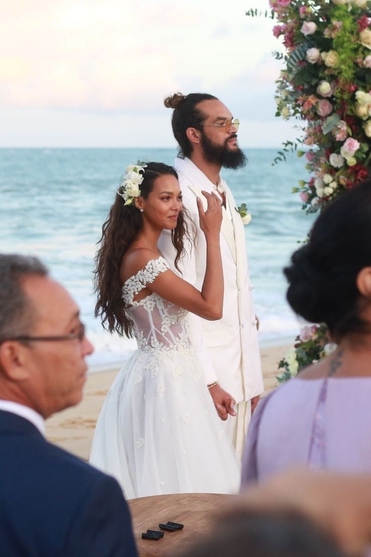 the bride and groom are getting married on the beach