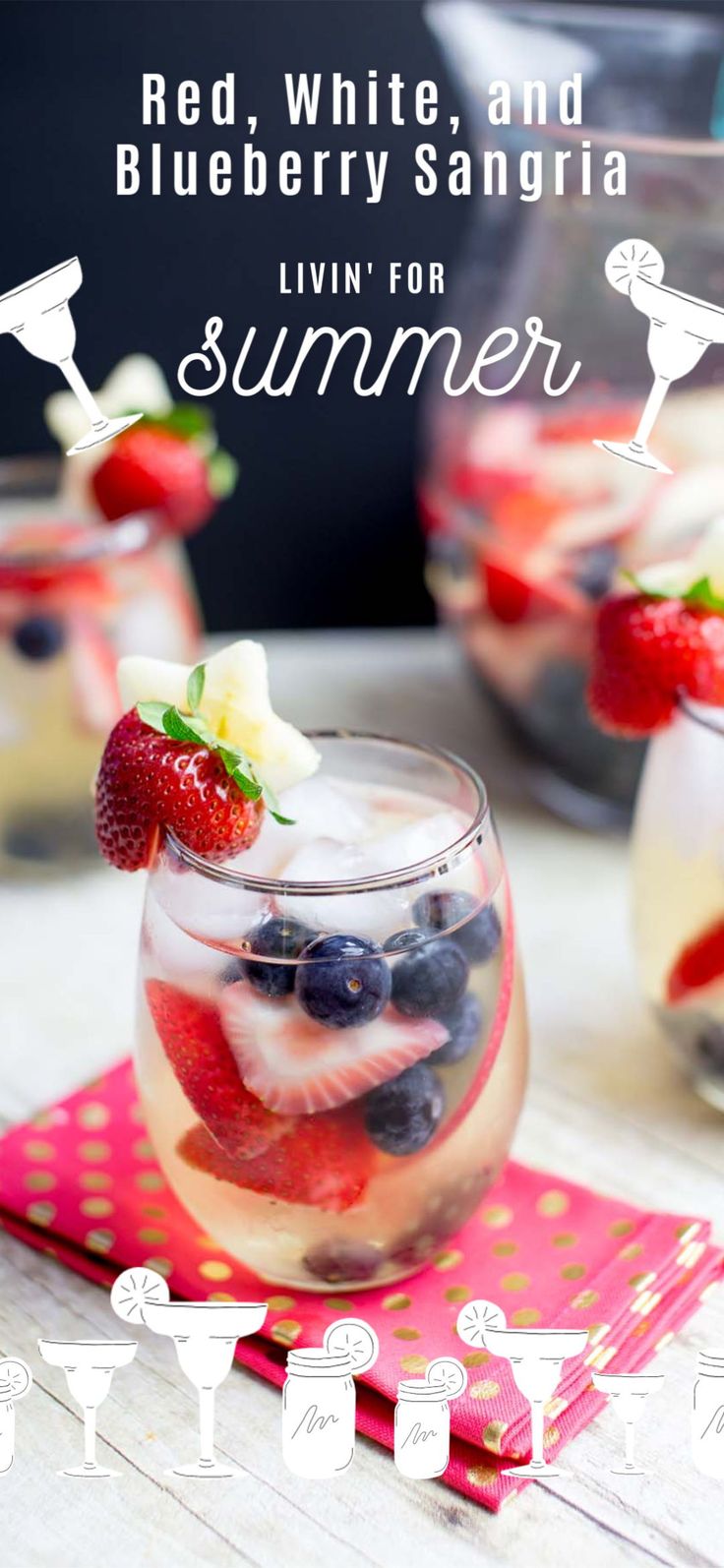 red, white and blueberry sangria in a glass with strawberries on top