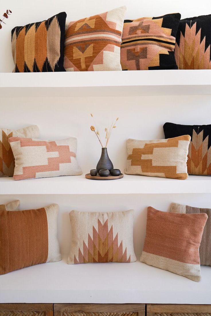 decorative pillows on shelves in a room