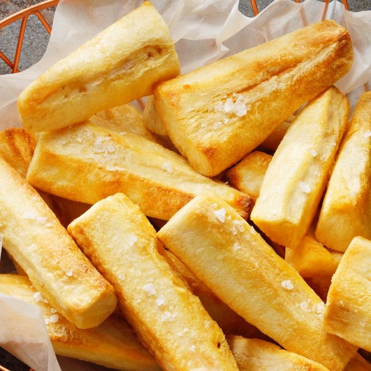 a basket filled with french fries sitting on top of a table