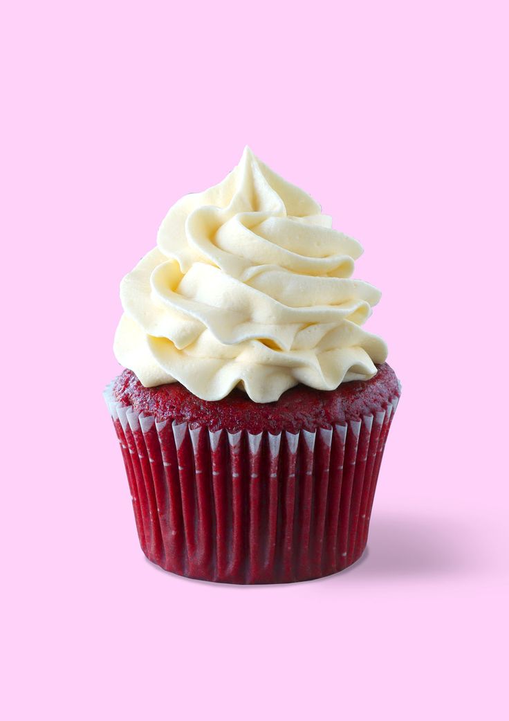 a red velvet cupcake with white frosting on a purple background, taken from above