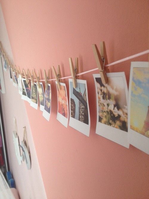 clothes pins are hanging on the clothes line with pictures pinned to it's sides