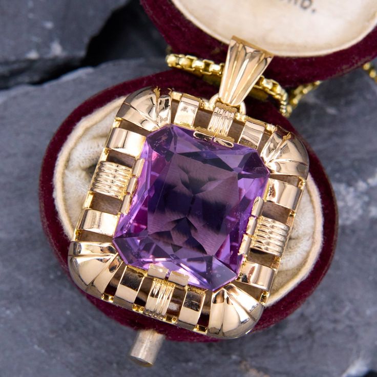 This fabulous large amethyst pendant is centered with a rectangular cut amethyst that is accented with a halo of high polished open gold work. The pendant is crafted in 14k yellow gold and is about 1.25" long. We have added an 18 inch long 14k yellow gold rounded box chain weighing approximately 3 grams. Classic Purple Jewelry With Rectangular Stone, Vintage Jewelry With Rectangular Pendant For Formal Occasions, Art Deco Jewelry With Rectangular Pendant As Gift, Art Deco Jewelry With Rectangular Pendant For Gift, Vintage Rectangular Pendant Jewelry For Formal Occasions, Art Deco Gold Jewelry With Rectangular Stone, Formal Art Deco Jewelry With Large Pendant, Antique Octagon Shaped Jewelry For Gifts, Elegant Purple Rectangular Necklace