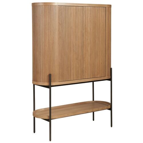 a wooden cabinet sitting on top of a metal shelf next to a white wall and black legs