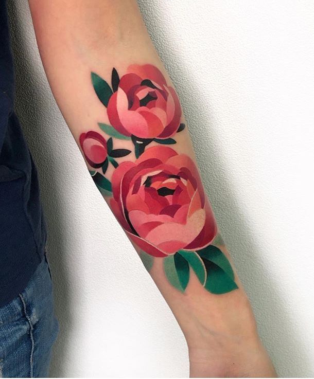 a woman's arm with red roses on it and green leaves in the middle