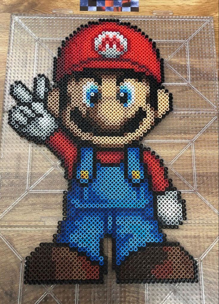 an image of a pixelated mario bros character on a wooden floor with the words super mario in front of it