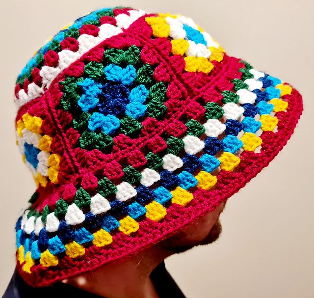 a man wearing a colorful crocheted hat