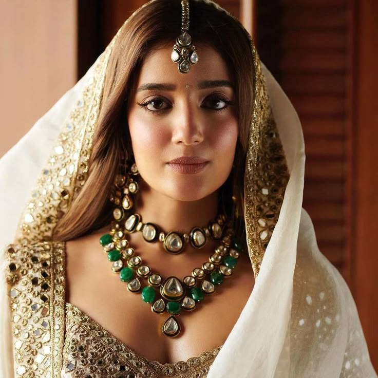 Capturing elegance, Inspired by Arpita Mehta's radiant knots: Unveil your love story with our exquisite jewelry set! Ensconced a classic attire with a beautiful kundan set inspired by age old techniques and decorated with emerald beads. The set includes a choker paired with a necklace, a maang teekah and a classic pair of earrings. Gold-plated on high-quality brass as base metal. Made by order. Kindly allow 5-7 weeks for the delivery of this item. For custom or urgent requests, please contact su Simple Bridal Makeup, Kunal Rawal, Arpita Mehta, Wedding Dress Indian, Mirror Work Lehenga, Lehenga Jewellery, Fashion Wedding Dress, Bridal Makeup Looks, Indian Bridal Makeup