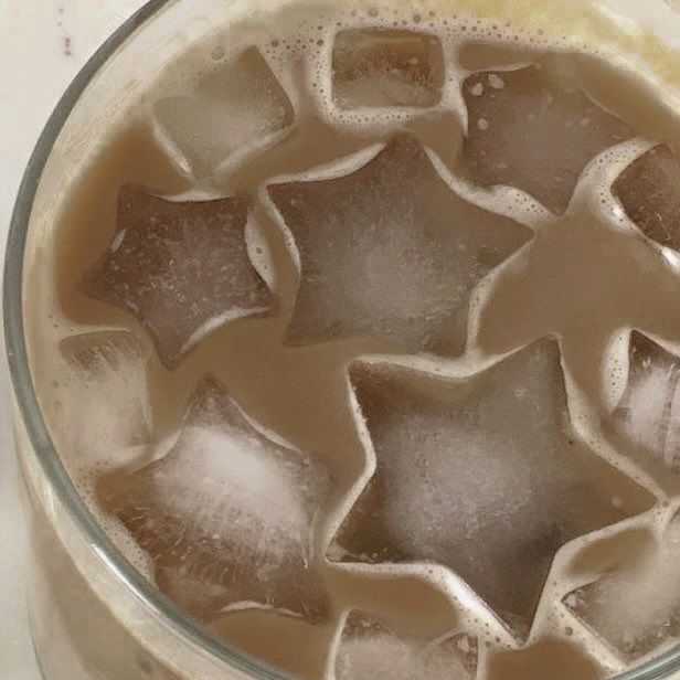 an iced drink with star shaped ice cubes in it