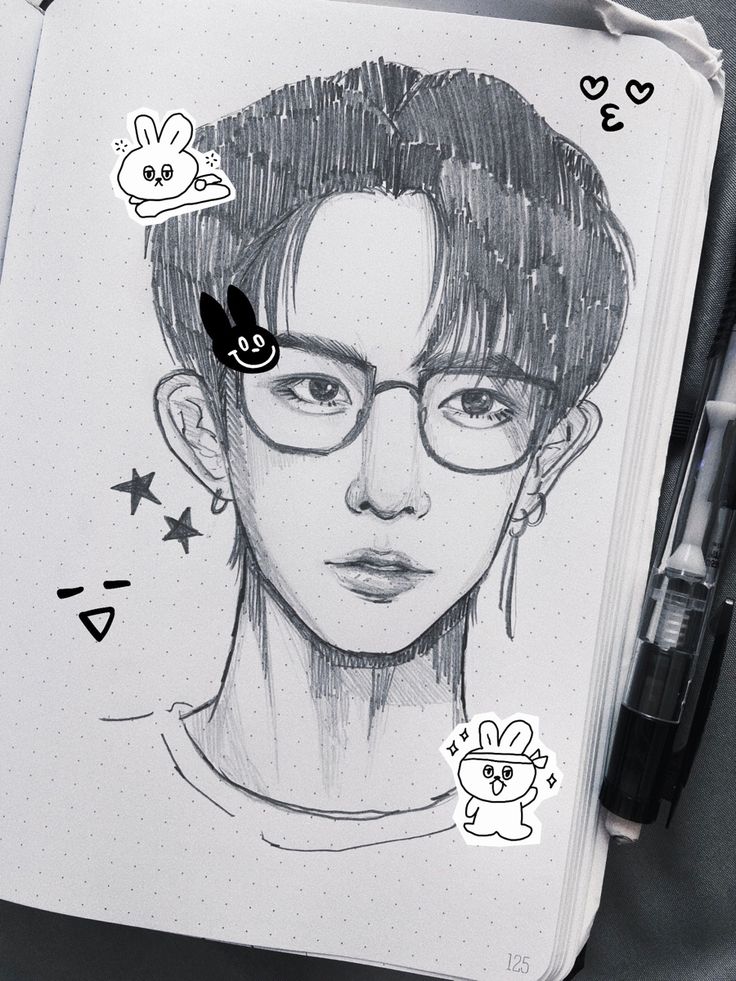 a drawing of a person with glasses and some stickers on their face, next to a pen