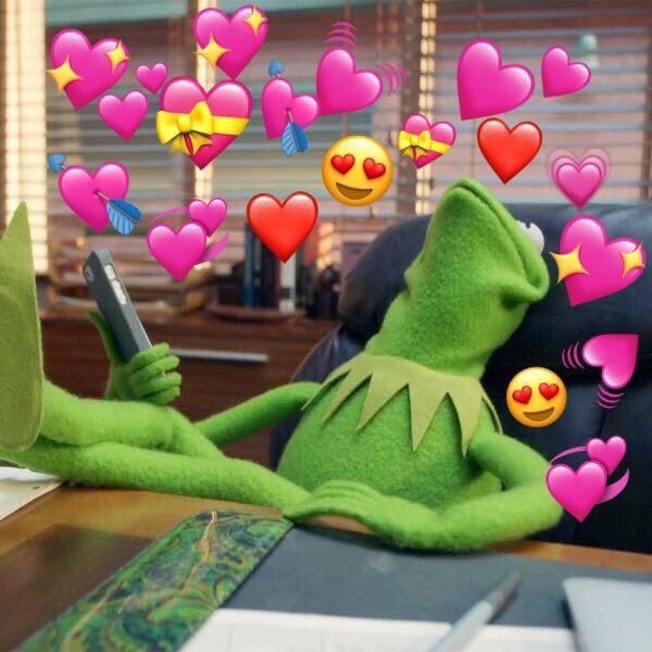 kermie the frog sitting on a couch surrounded by hearts and other emoticions