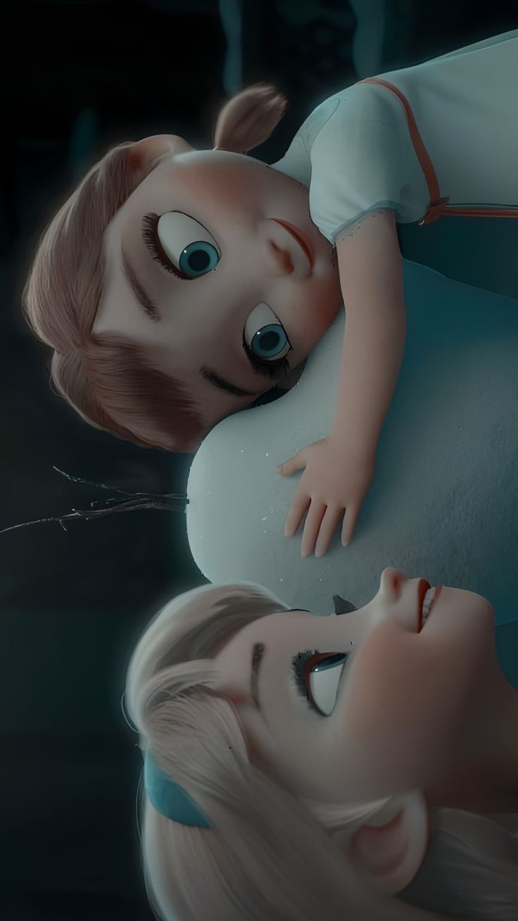 two dolls laying on top of each other in front of a woman's face