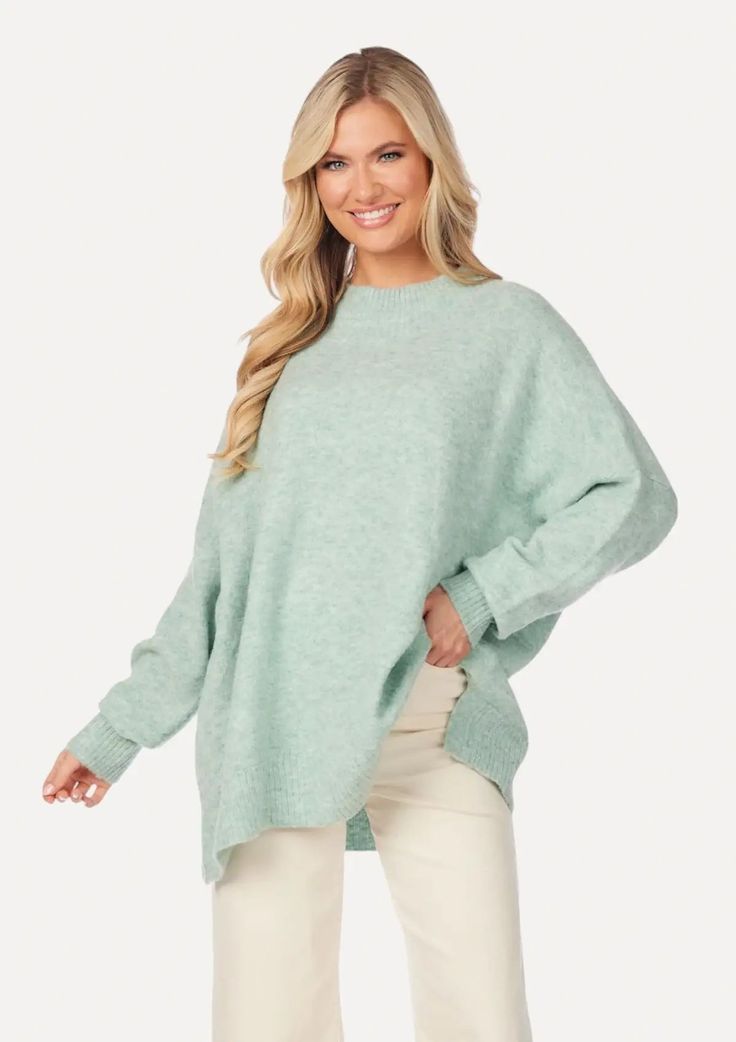 The Monica Crew Neck Sweater is the perfect blend of style and warmth. Its oversized fit and green hue create a bohemian-inspired haven, while the ribbed hems and mock neckline add a classic layer-able touch. Soft Knit Green Sweater For Layering, Oversized Funnel Neck Sweater For Spring, Winter Green Sweater With Ribbed Neckline, Green Winter Sweater With Ribbed Neckline, Green Funnel Neck Sweater For Fall, Oversized Green Textured Knit Outerwear, Spring High Neck Outerwear For Layering, Oversized Green Ribbed Sweater, Green Ribbed Sweater For Layering