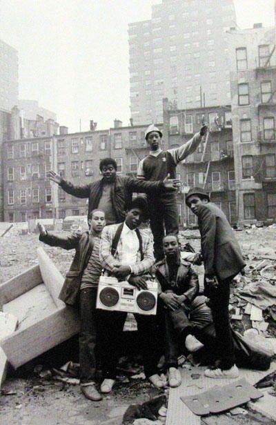 a group of men standing next to each other on top of a pile of rubble