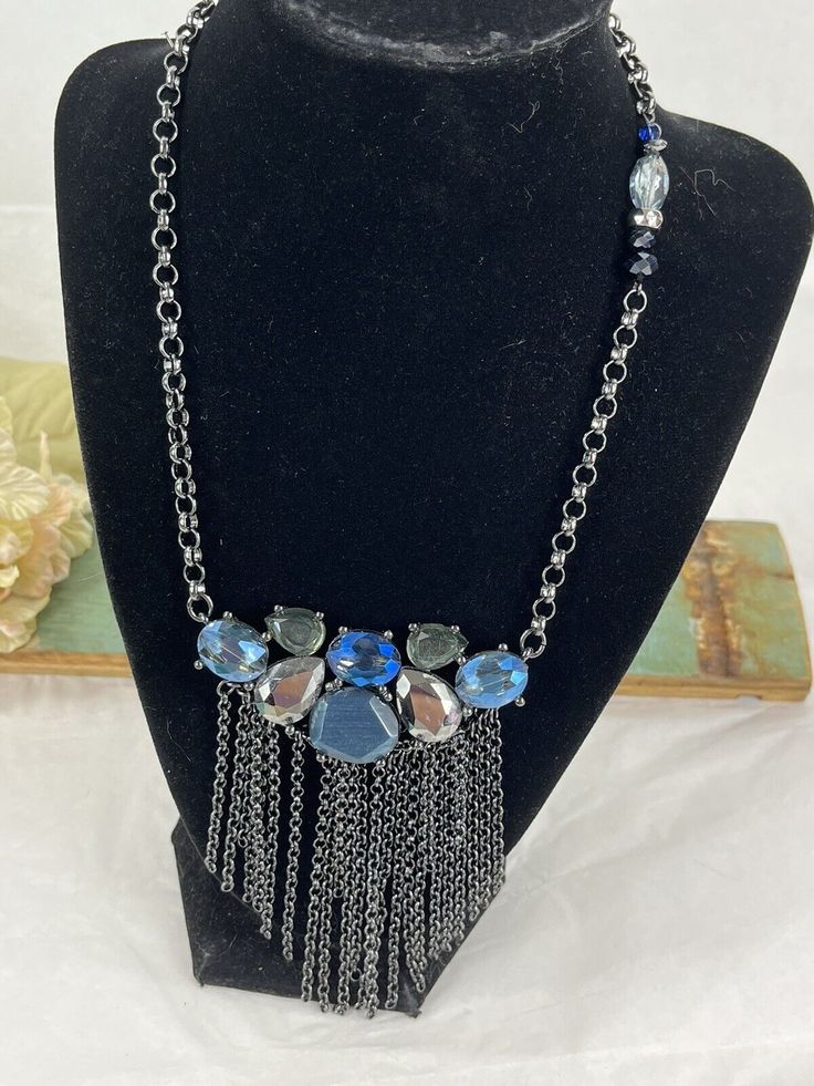 Add a bohemian touch to your outfit with this Chico's Panel Blue Glass Necklace. The necklace features a unique panel style with blue glass beads and an unknown metal base. Perfect for any occasion, this necklace is sure to add a pop of color to your look. The necklace measures [insert measurements here] and is ideal for those who love to add a little bit of flair to their wardrobe. Get ready to turn heads with this trendy and stylish necklace! Blue Bohemian Necklaces For Party, Turquoise Glass Necklaces For Party, Turquoise Glass Necklace For Party, Blue Bohemian Crystal Necklaces For Party, Blue Bohemian Crystal Necklace For Party, Blue Costume Jewelry Necklace With Chain, Blue Long Necklace For Party, Bohemian Blue Crystal Party Necklace, Turquoise Glass Party Necklace