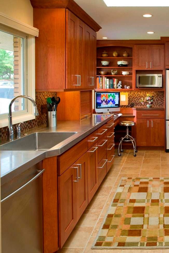 a kitchen with wooden cabinets and stainless steel appliances