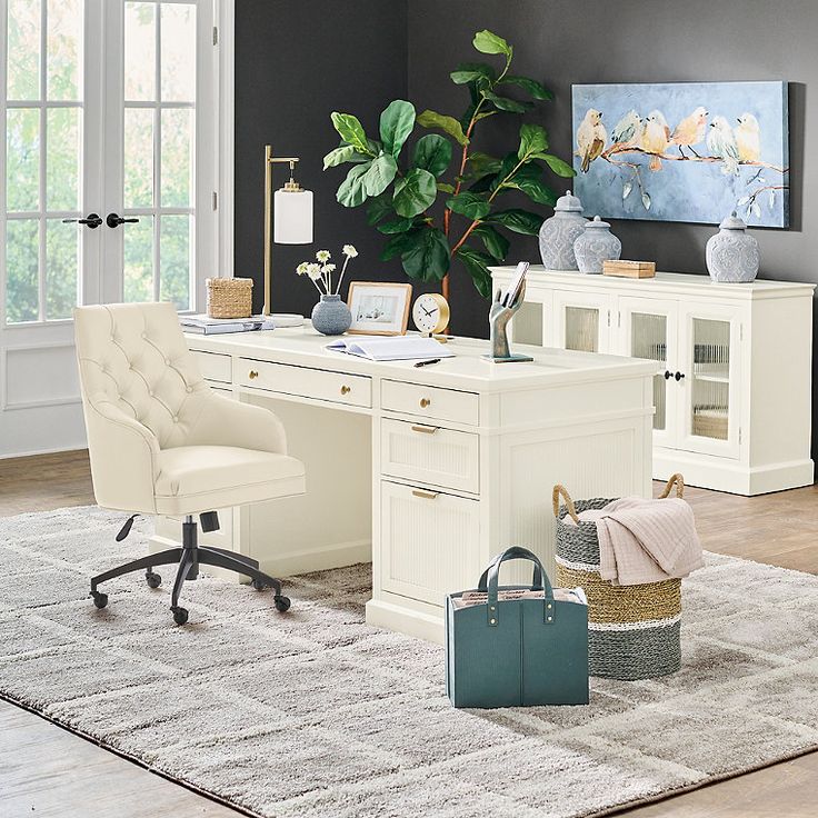 a white desk and chair in a room with a large potted plant next to it