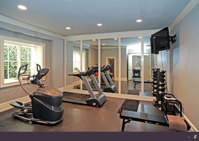 an exercise room with cardio machines and treadmills