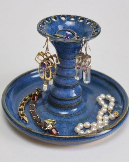 a blue vase with some jewelry on it