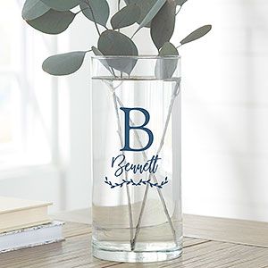 a vase with some flowers in it sitting on a table next to a bookshelf