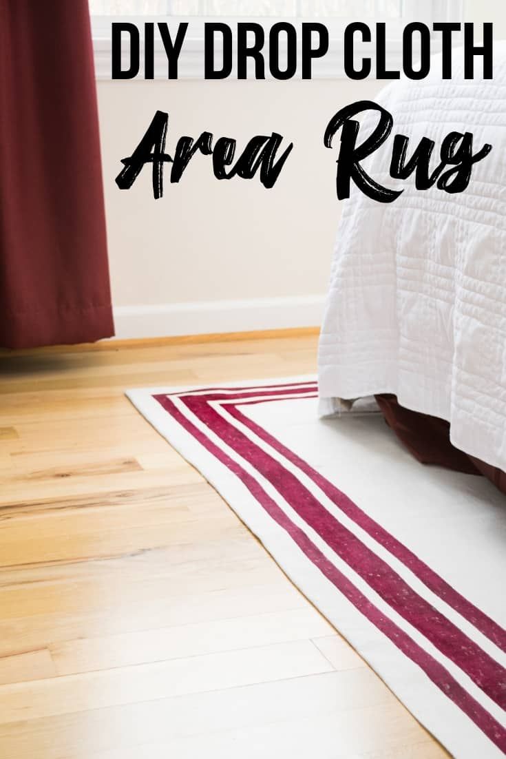 a white bed sitting on top of a wooden floor next to a red and white rug