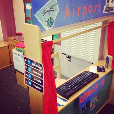 an airport check - in desk with a keyboard and monitor on it's side