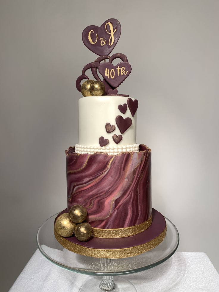 a three tiered cake decorated with hearts and the words i love you on top