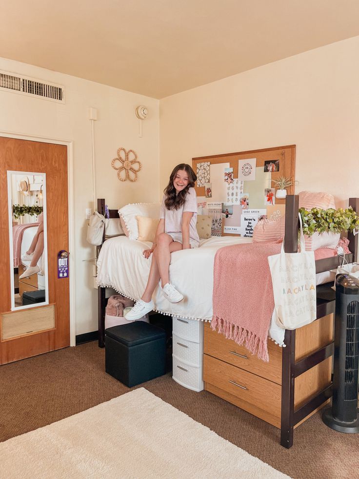 a woman sitting on top of a bed in a bedroom