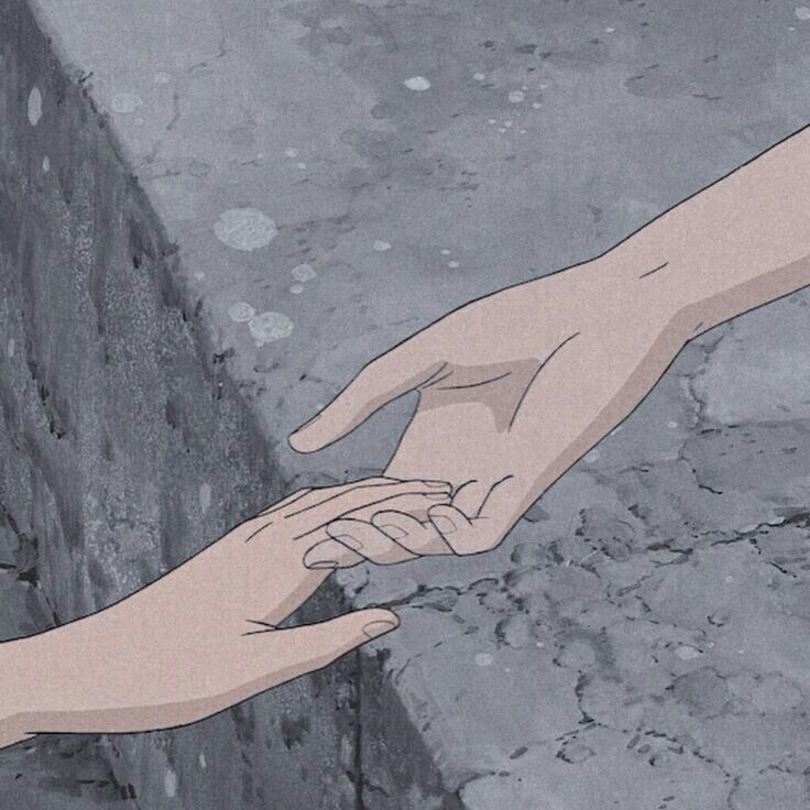 two hands reaching for each other over a brick wall