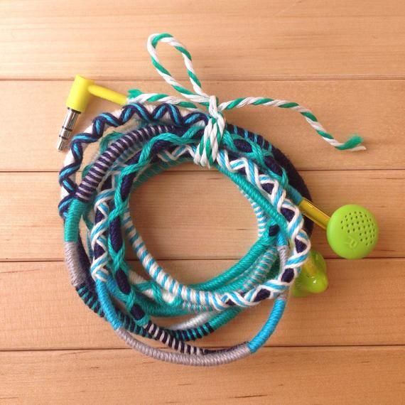 several bracelets with headphones on top of a wooden table