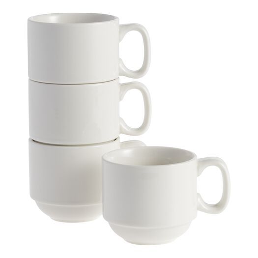 three white coffee mugs stacked on top of each other in front of a white background