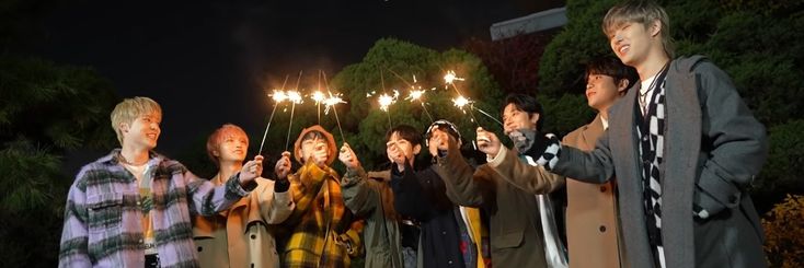 a group of people holding sparklers in their hands