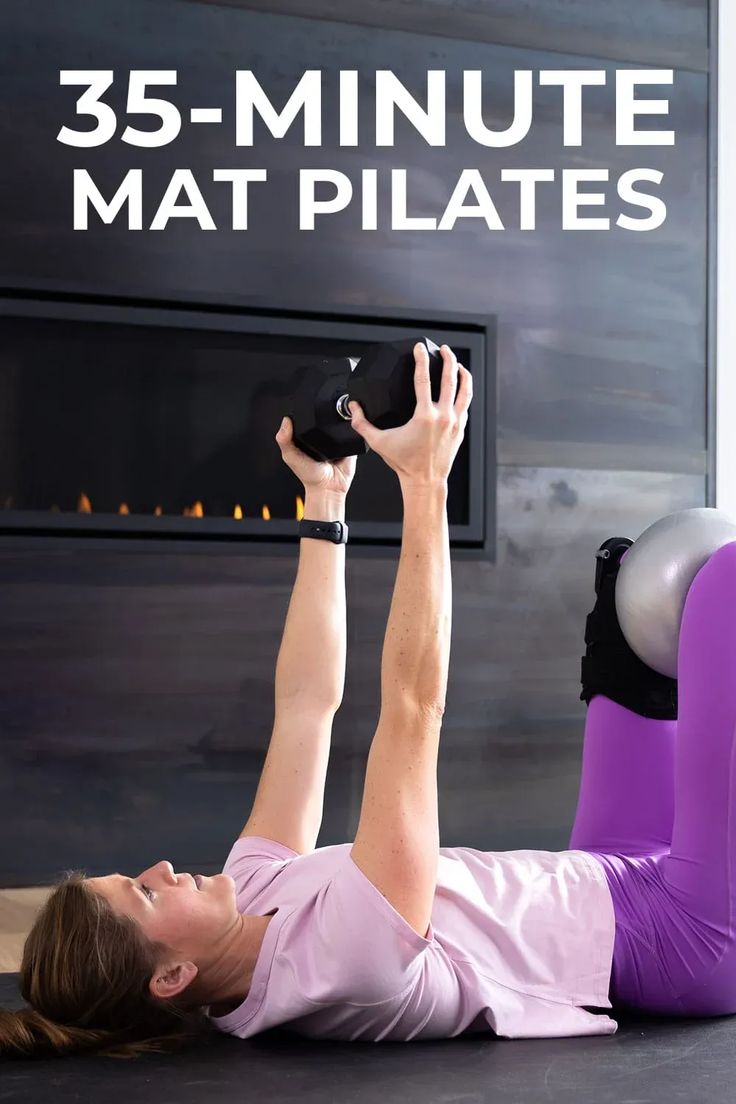 a woman laying on the floor with her legs up and holding a kettle in front of her