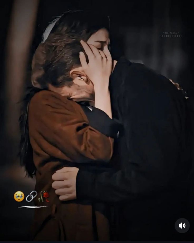 two people hugging each other in the dark with one person covering their face and another holding his head