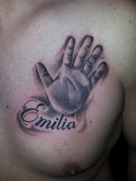 a man's chest with a hand tattoo on it that says, enrila